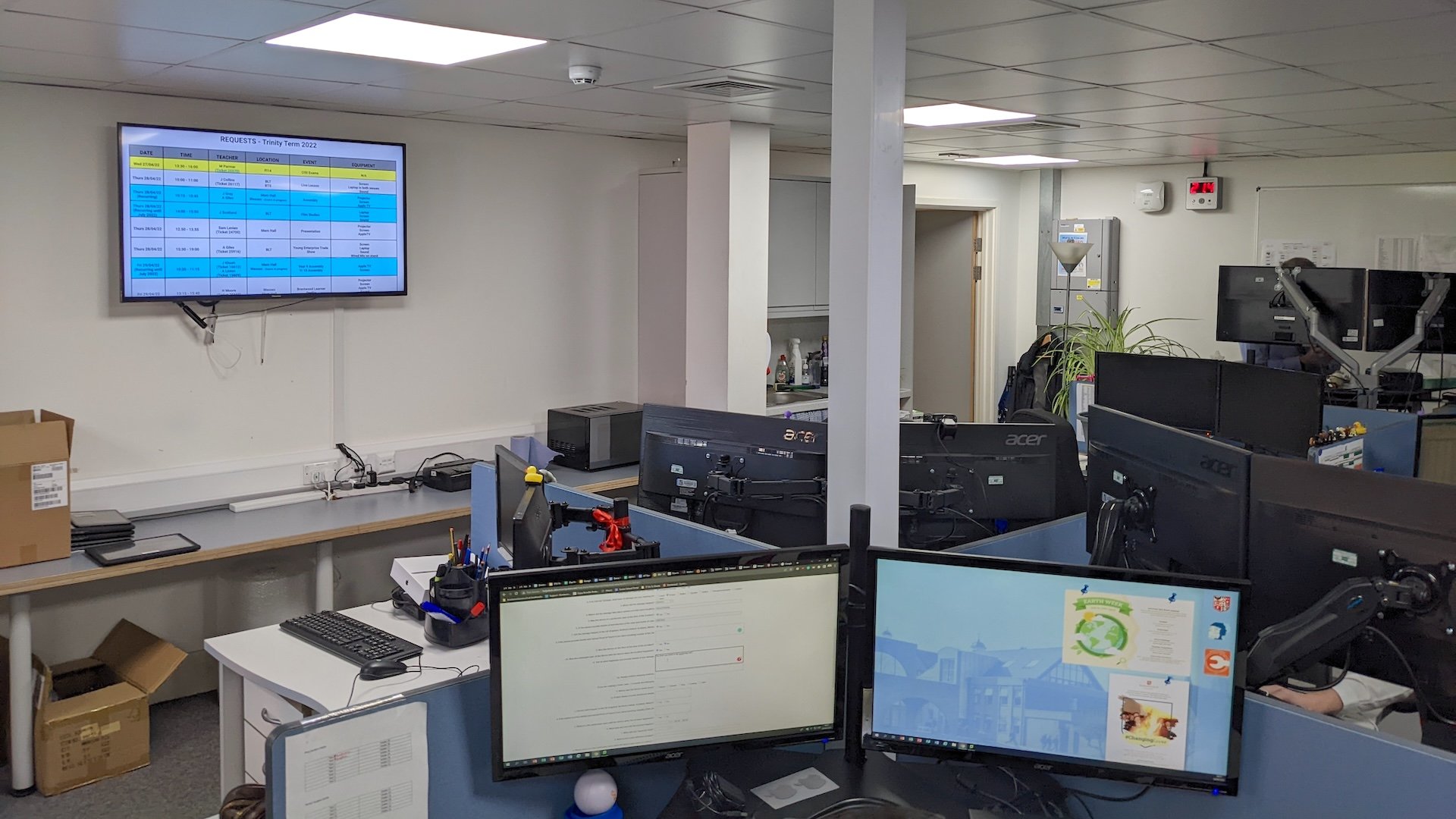 A digital signage screen displaying content in an office at Brentwood school