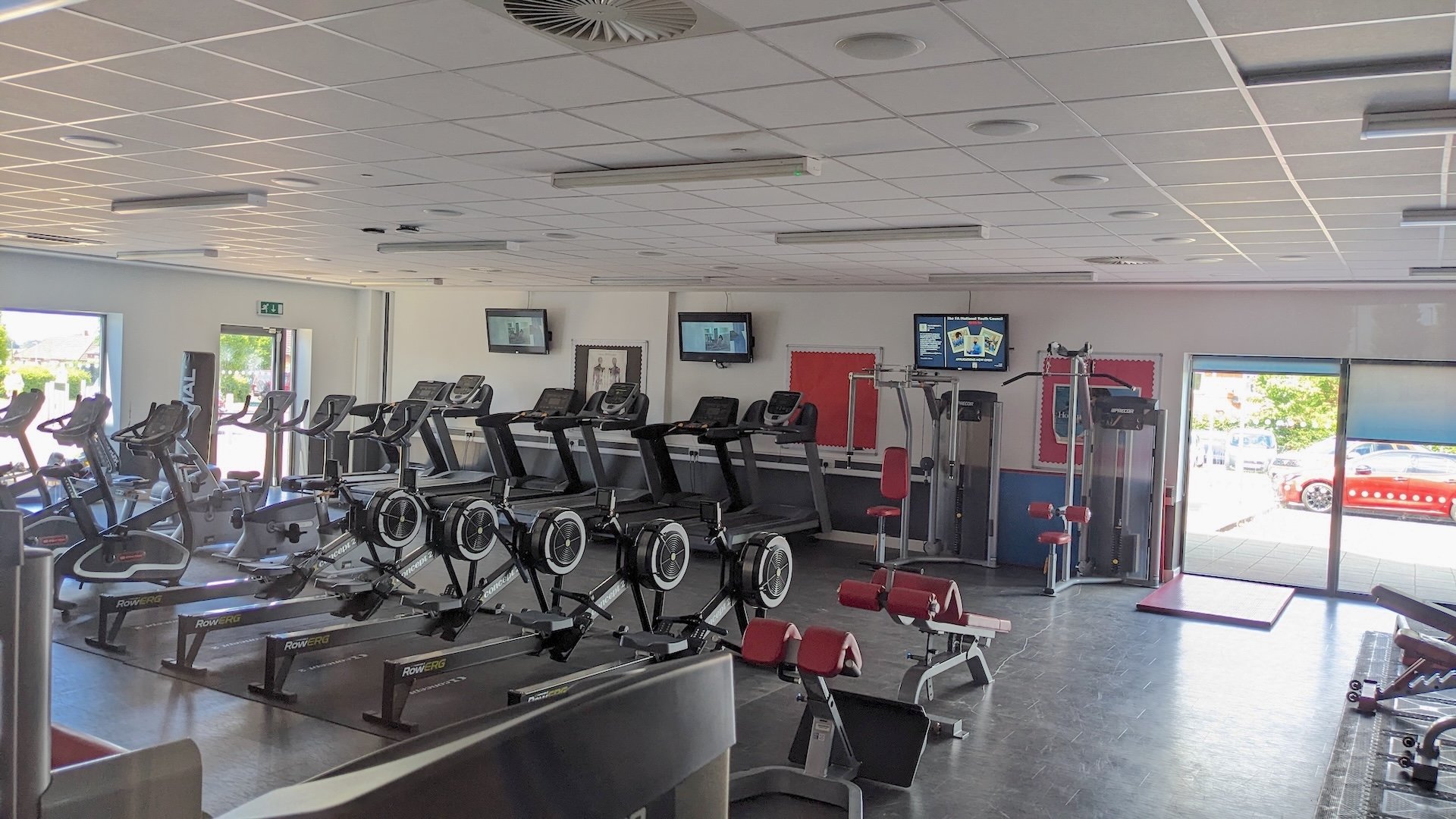 The discovery academy gym with screens showing content displayed via TrilbyTV